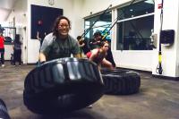 Two students joyfully flipping tires at the ARC